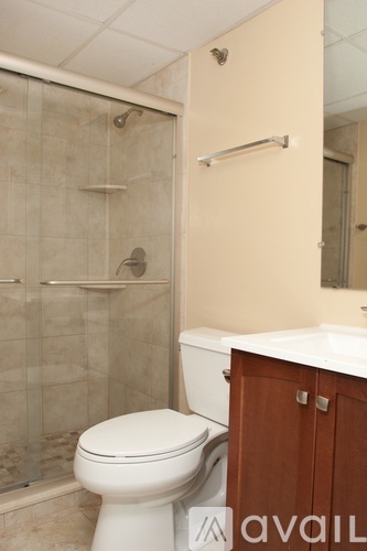 A bathroom with a toilet, sink, and shower.