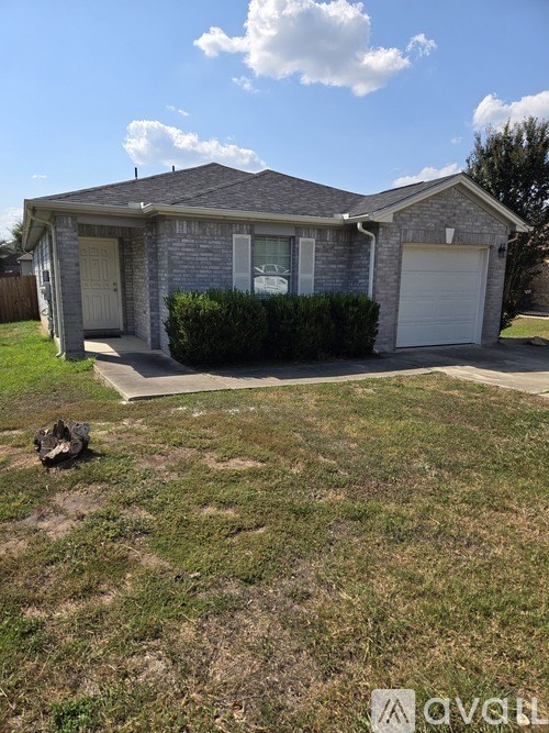 A house with a grey roof and a white garage door.