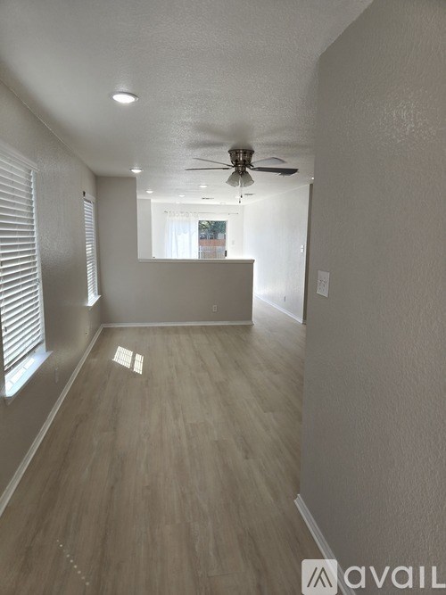 A room with a ceiling fan and lighting fixtures.