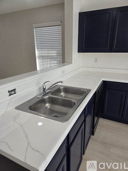 A kitchen with a sink and a window.