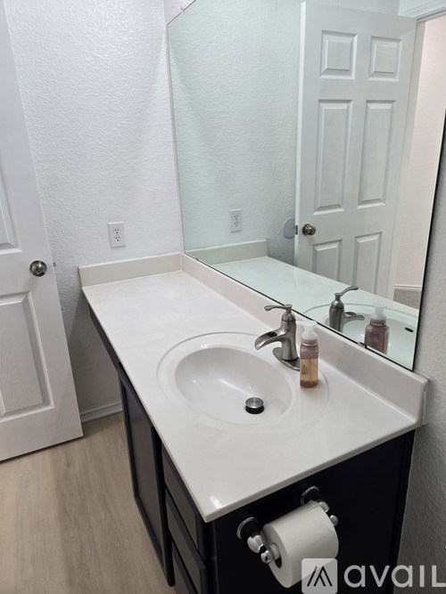 A bathroom sink with a mirror above it.