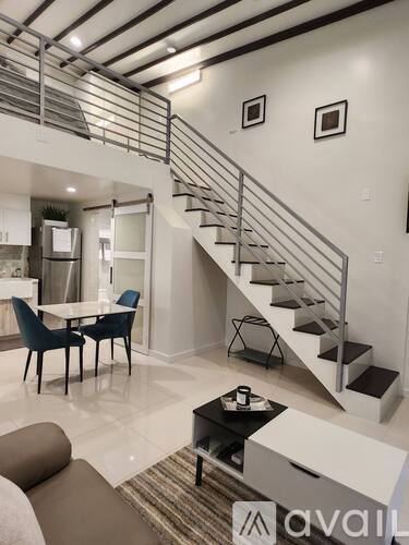 A living room with a staircase leading to the upper floor.