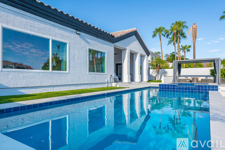 A modern house with a pool in the backyard.