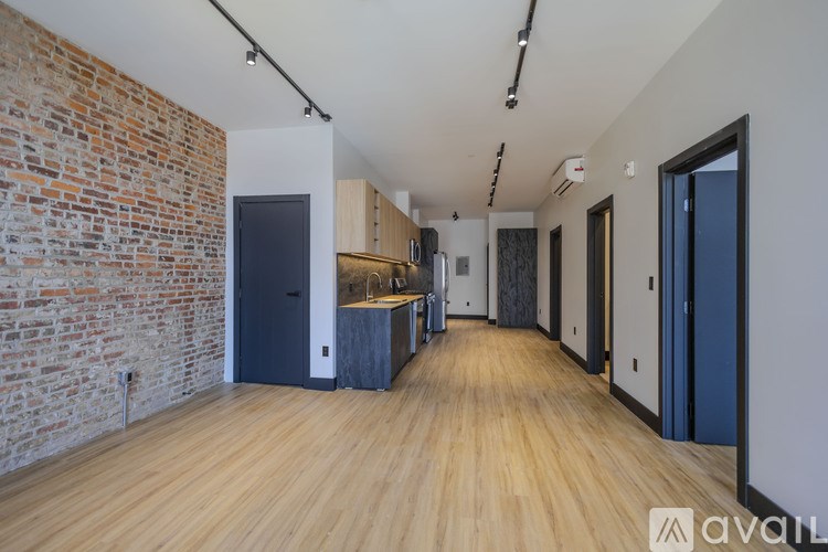A room with a brick wall and wooden flooring.