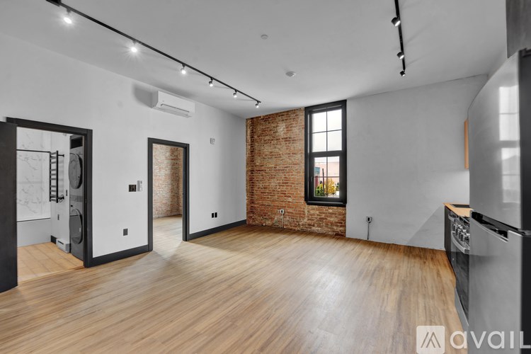 A room with a brick wall and a wooden floor.