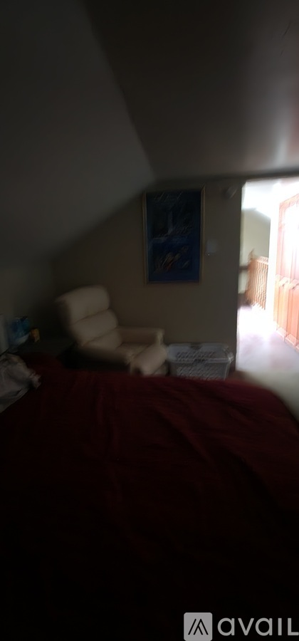 A bedroom with a bed and a painting on the wall.