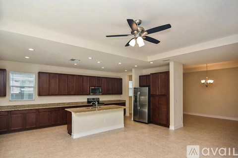 A kitchen with brown cabinets and a white island.