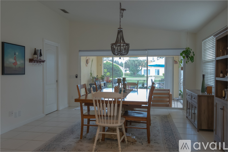 A dining room with a wooden table and chairs.