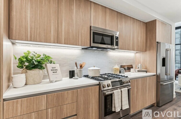 A kitchen with wooden cabinets and a stainless steel stove.