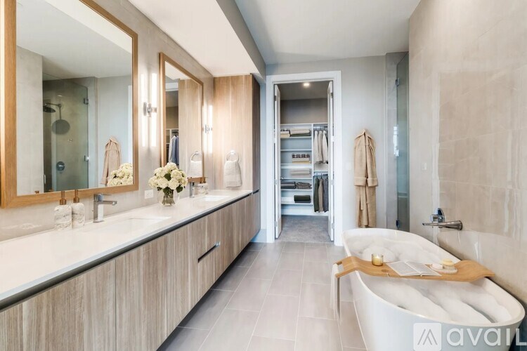 A modern bathroom with a large tub and a walk-in shower.