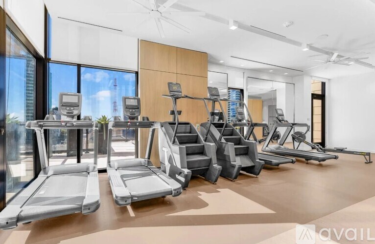 A gym with treadmills, elliptical machines, and a stair climber.