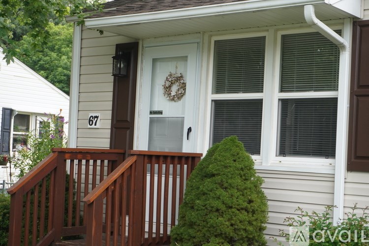 A house number 67 with a door and a window.