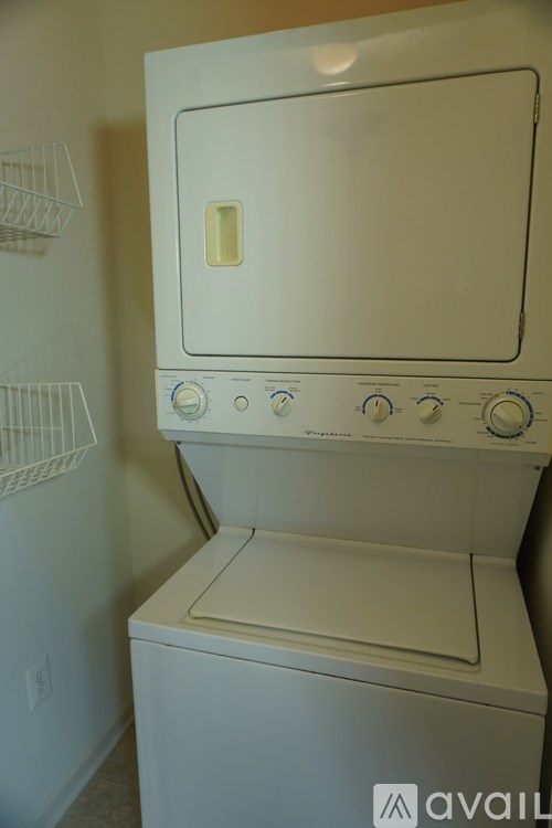 A white dryer and washer are stacked on top of each other.