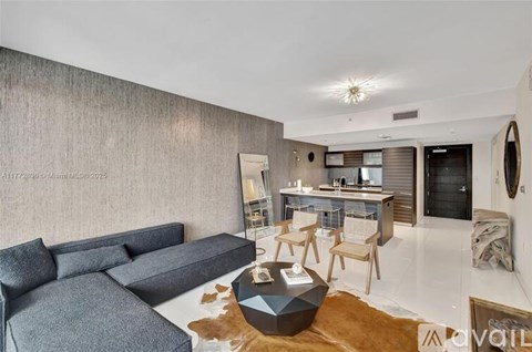 A modern living room with a grey sofa and a wooden coffee table.