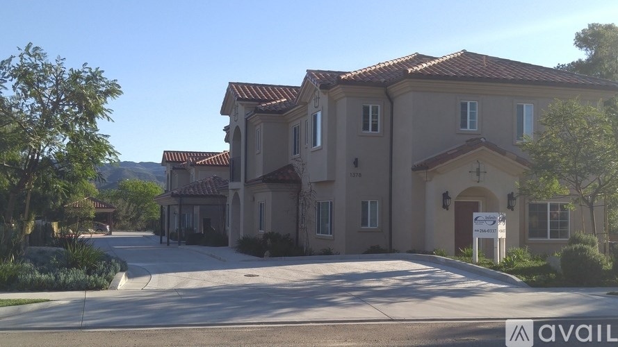 A large house with a driveway in front of it.