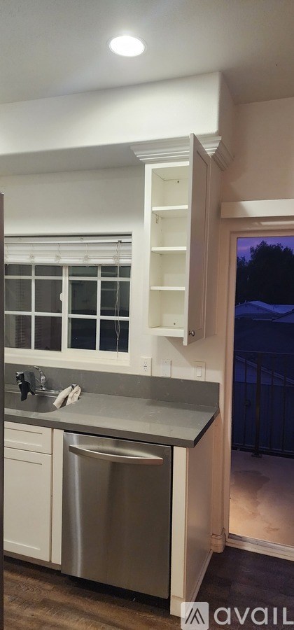 A kitchen with a sink and a cabinet.