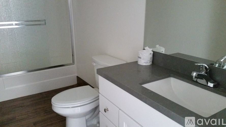 A white toilet sits next to a sink in a bathroom.