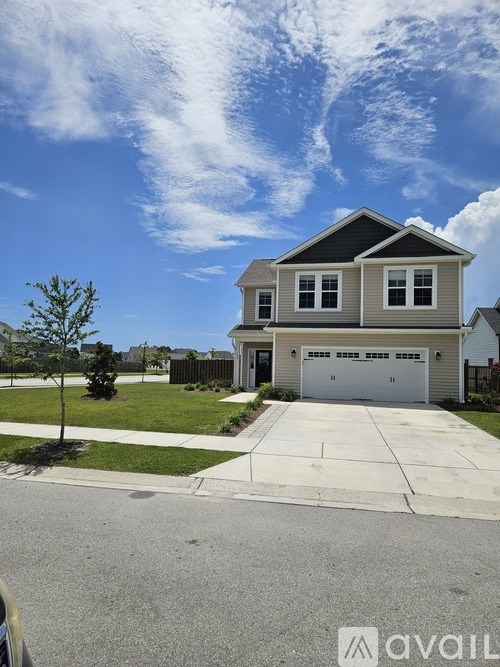 A two-story house with a garage is for sale.