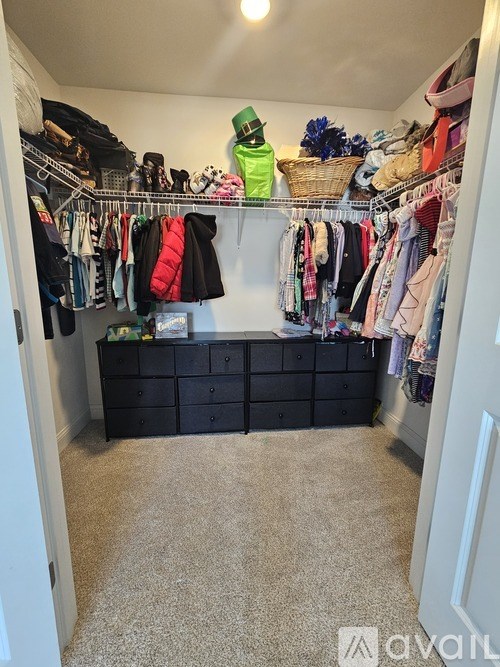 A black dresser with a black coat on top of it.