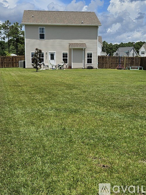 A house with a lawn in front of it.