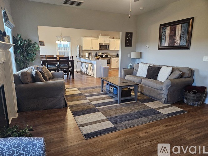 A living room with a grey couch and a coffee table.