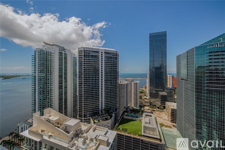 A view of a cityscape with tall buildings and a clear sky.