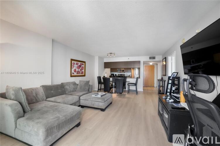 A living room with a grey sofa and a coffee table.