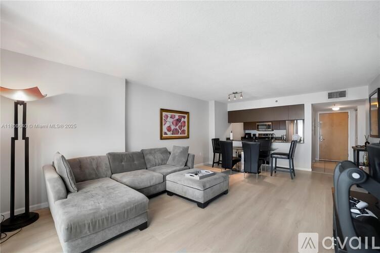 A living room with a grey sofa and a black floor lamp.