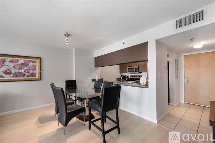 A dining room with a glass table and chairs.