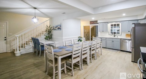 A dining area with a table set for six with blue plates.