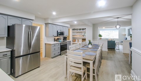 A modern kitchen with a dining table set for four.