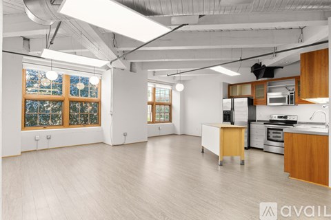 A spacious kitchen with wooden cabinets and a white countertop.