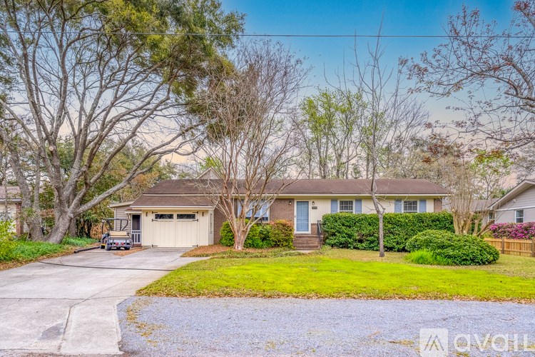 A house with a driveway and a car parked in front.