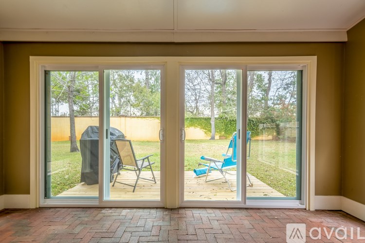 A patio with a table and chairs is visible through the sliding glass doors.
