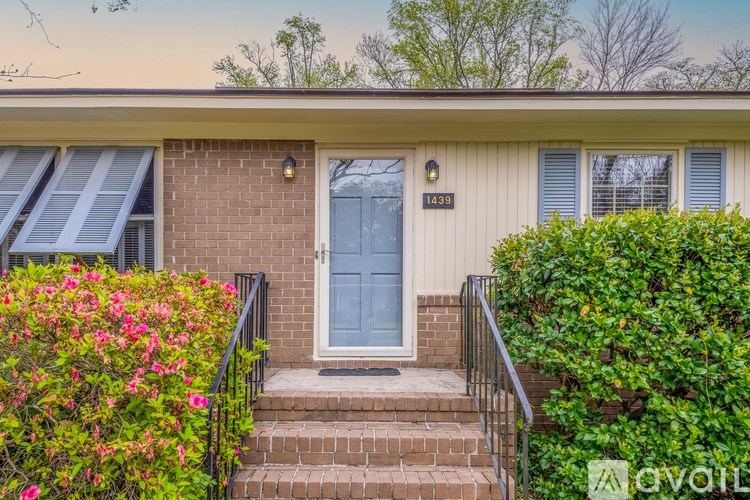 A house with a blue door and a sign that reads "1439" is shown.