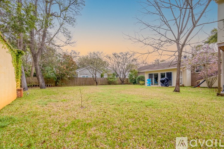 A backyard with a lawn and trees.