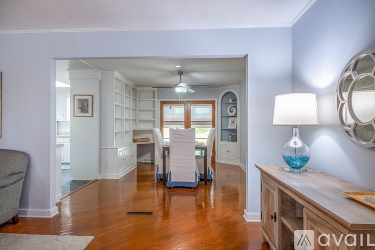A living room with a grey couch and a wooden table.