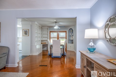 A living room with a grey couch and a wooden table.