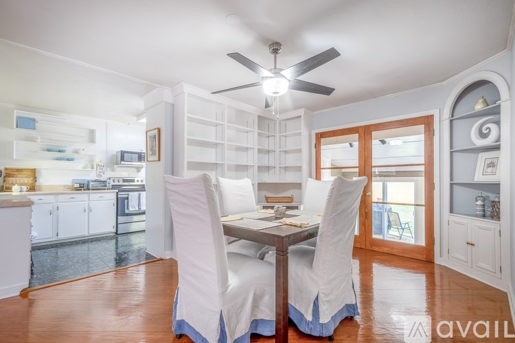 A dining room with a table and chairs.
