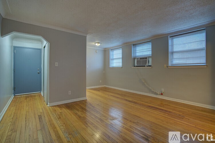 A room with wooden floors and a blue door.