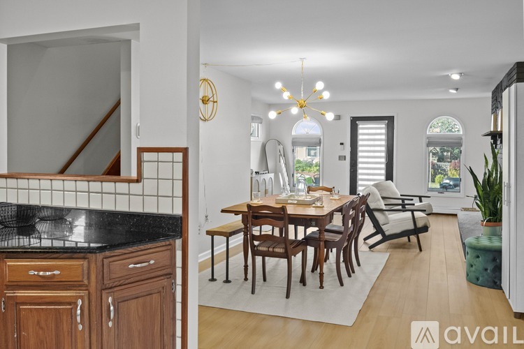 A kitchen with wooden cabinets and a dining table with chairs.