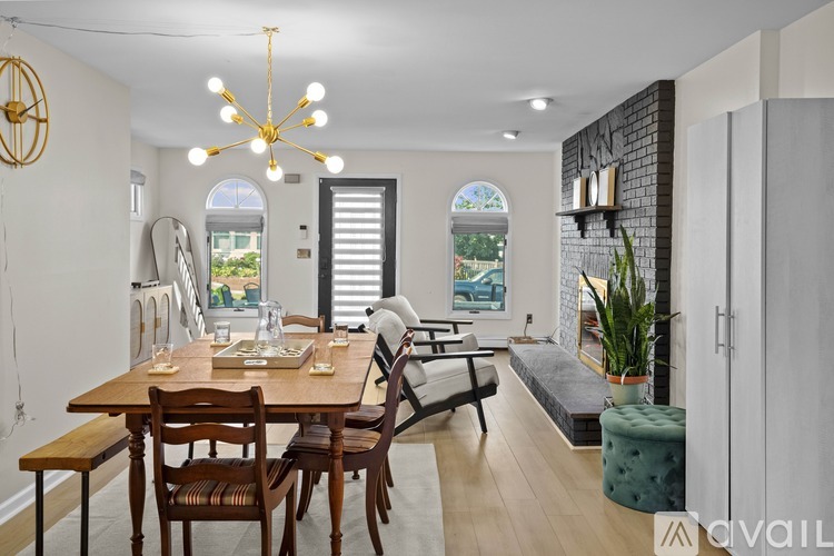 A dining room with a wooden table and chairs.