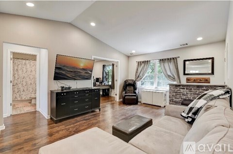 A living room with a large couch and a flat screen TV.