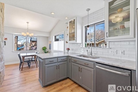 A kitchen with a dining table and chairs.