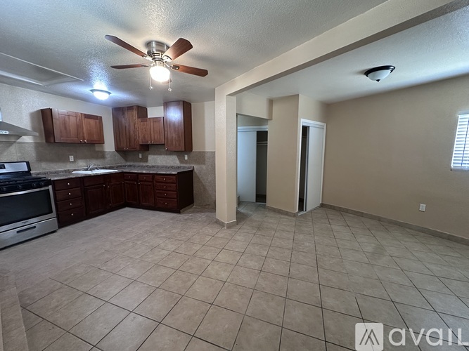 A kitchen with white cabinets and a granite countertop.