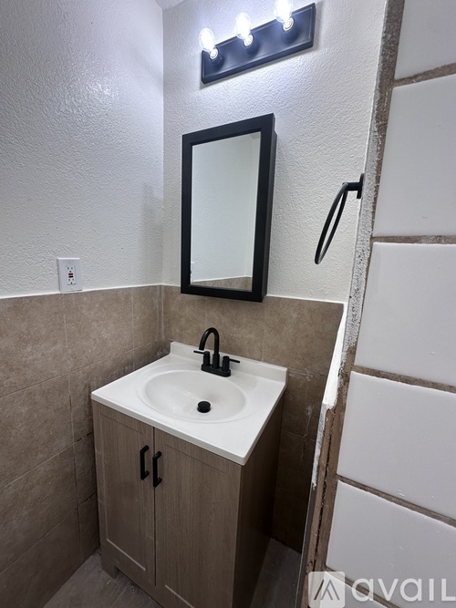 A white door in a room with wooden floors and beige walls.