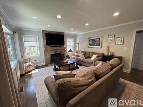 A living room with a large couch and a fireplace.