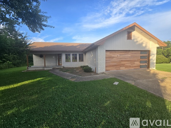 A house with a brown roof and a garage door.