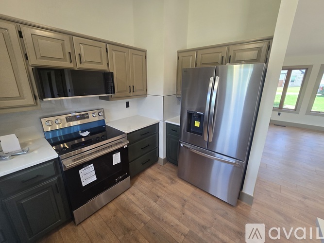 A kitchen with a stove top oven and a refrigerator.