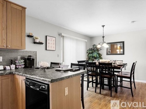 A kitchen with a dining table and chairs.
